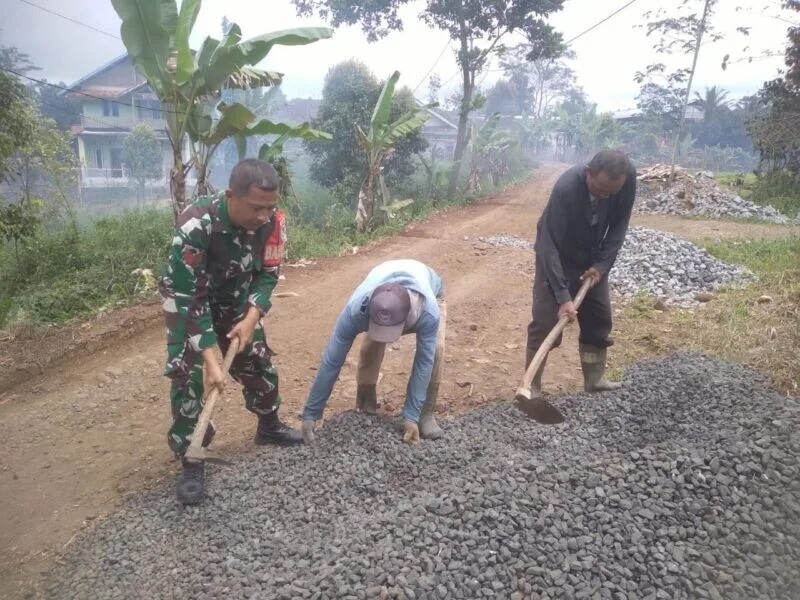 Babinsa Koramil 2207/Jampangtengah Laksanakan Karya Bakti Pengerasan Jalan Bersama Warga