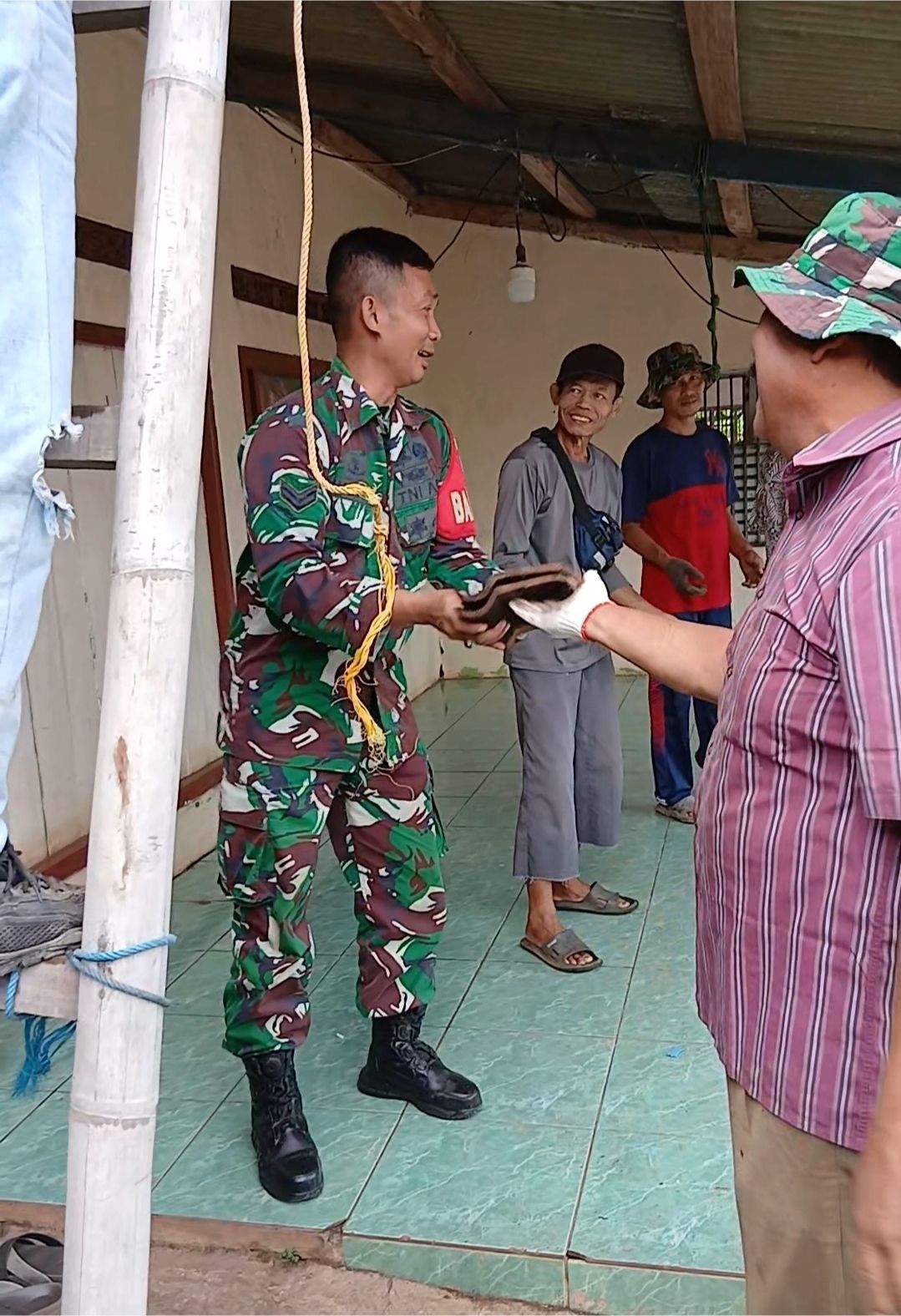Babinsa Desa Cibodas Bantu Warga Turunkan Genteng Rumah yang Akan Direhab,Wujud Nyata Semangat Gotong Royong