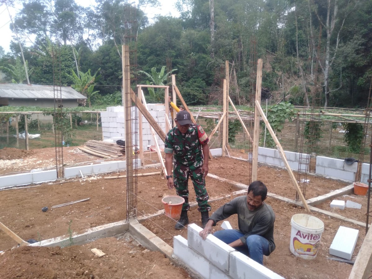 Babinsa Desa Sukamaju Serda Deni Laksanakan Bakti Pembangunan Rumah Warga di Kecamatan Nyalindung